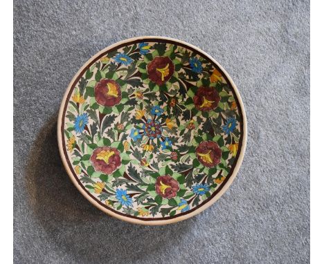 A large ceramic Persian shallow bowl with allover floral pattern. Dia.40cm 