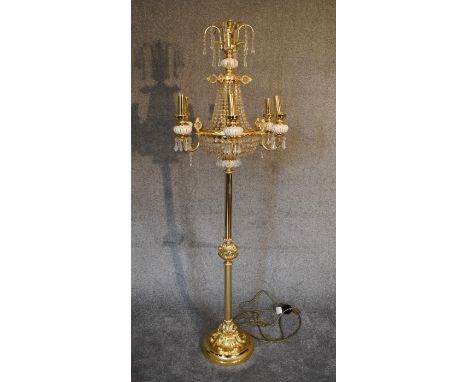 A gilt metal and crystal floor standing six branch chandelier. 1.8m tall. 