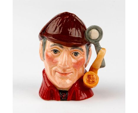 Modeled in brown deerstalker hat and red cloak.Royal Doulton small character jug with a handle in form of a pipe and magnifyi