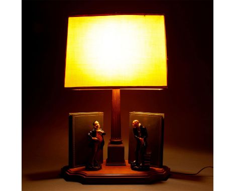 On a custom wooden base with two decorative stylized books and a central bronzed metal column for the electrical fixture.A gr