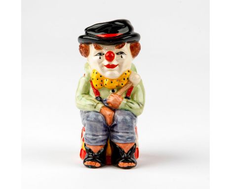 Colorful clown seated on his yellow and red drum.Royal Doulton toby jug of a clown in green shirt; blue trousers; yellow bow 