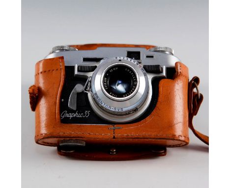 Mid-century rangefinder with extremely novel push button focus.35mm.  Issued: c. 1950 Dimensions: 6"L x 4"H x 3"W (in case) M