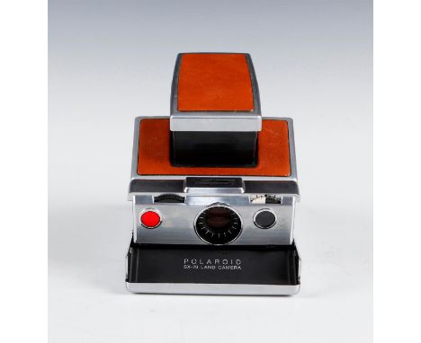 An iconic folding instant camera from the 1970s. Issued: Mid 20th c. Dimensions: 5.5"H X 7"L X 4"D Manufacturer: Polaroid Cor