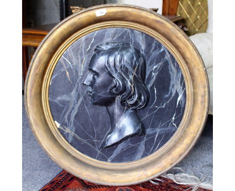 A LATE 19TH CENTURY CIRCULAR PLASTER RELIEF PORTRAIT with a black marbled paint effect and mounted in a gilded wood and gesso