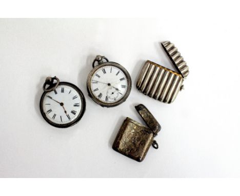 TWO SILVER CASED POCKET WATCHES with white enamel dials, a Birmingham silver engraved vesta case and a white metal vesta case