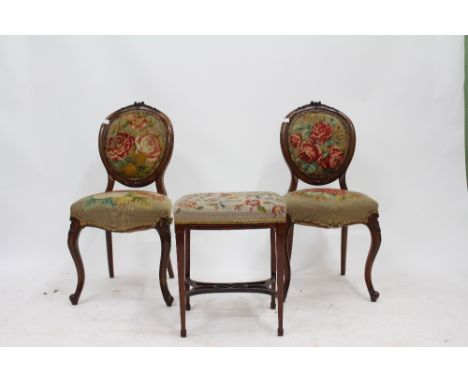 A PAIR OF VICTORIAN MAHOGANY FRAMED BALLOON BACK CHAIRS with rose tapestry upholstered seats and backs and cabriole legs toge