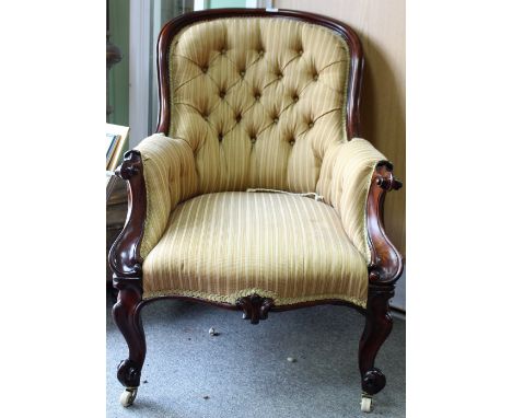 A VICTORIAN ROSEWOOD FRAMED BUTTON UPHOLSTERED ARMCHAIR with scrolling arms, cabriole legs, terminating in ceramic castors 64