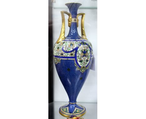 A ROYAL WORCESTER TWIN HANDLED OVOID VASE standing on spreading socle base with hand painted floral decoration on blue mottle