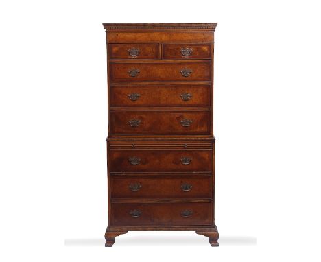 A REPRODUCTION MAHOGANY AND BURWOOD VENEERED CHEST ON CHEST  with two short and six long drawers, brass handles and ogee brac