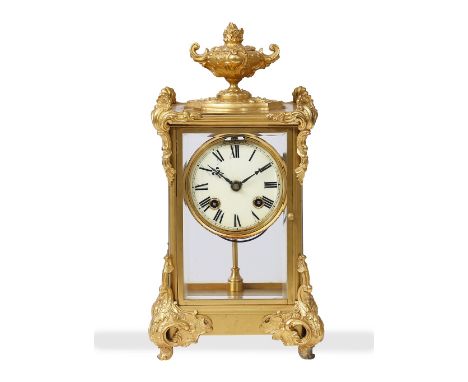 THE ANSONIA CLOCK COMPANY GILT MANTLE CLOCK with an urn finial, acanthus leaf mounts and an enamel dial with Roman numerals, 