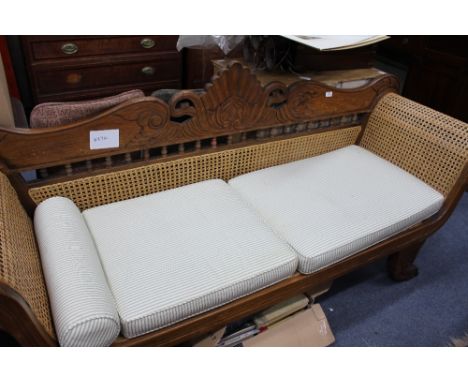 A PERANAKAN HARDWOOD SOFA with carved decoration and caned seat and scrolling arms, 204cm wide together with a peranakan hard