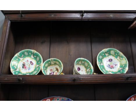A PAIR OF 19TH CENTURY ROCKINGHAM POTTERY COFFEE CUPS AND SAUCERS decorated with flowers within an apple green ground, each s
