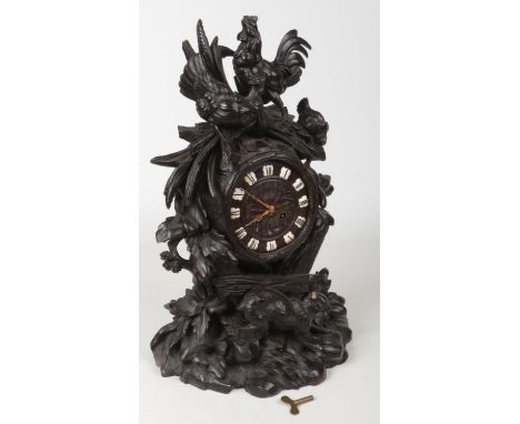 A 19th century Black Forest walnut mantel clock. Naturalistically carved with a cockerel, hen and a hare amidst foliage and w