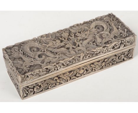 A Chinese silver plated rectangular box and cover. Cast in relief with dragons chasing a flaming pearl. Six character Qianlon