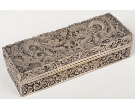 A Chinese silver plated rectangular box and cover. Cast in relief with dragons chasing a flaming pearl. Six character Qianlon