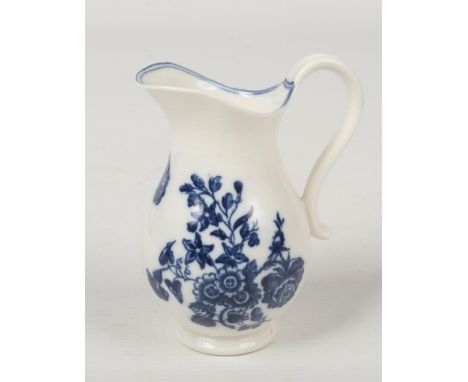 A small Caughley baluster shaped ewer with reeded scroll handle. Printed in underglaze blue with the Three Flowers pattern. P