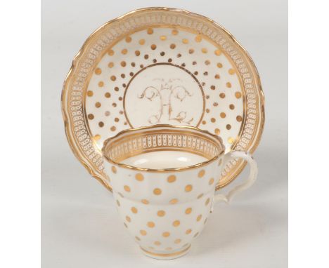 A Caughley coffee cup and saucer of ogee form and with scalloped rim. Decorated in gilt with a polka dot pattern and initial 