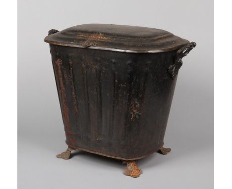 A Victorian toleware coal scuttle raised on trefoil bracket feet, 50cm high.  