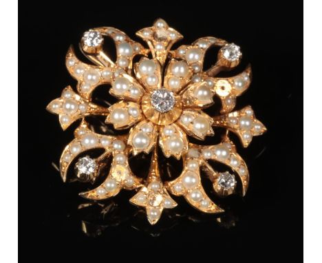 A cased 18 carat gold, diamond and pearl starburst brooch. Set with five round cut diamonds, principle stone approximately 0.