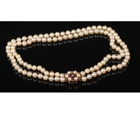 A two row cultured pearl necklace. With 9 carat gold starburst clasp set with pearls and garnets, 42cm.  Good condition.