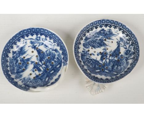 Two Caughley egg drainers. Both printed in underglaze blue with the Fisherman and Cormorant pattern. One with a rustic branch