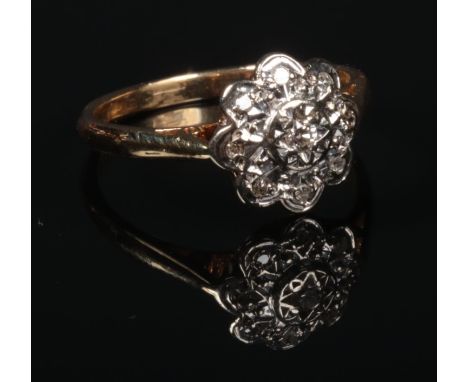 An 18 carat gold and diamond daisy cluster ring. 2.8 grams, size K.  Good condition.