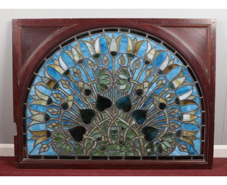 A pair of secessionist movement stained and leaded arch top room dividers in mahogany frames, 140cm wide, 104cm high. Glass 9