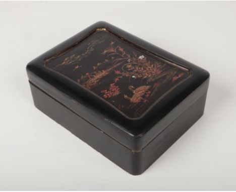 A Japanese Meiji period lacquered box and cover of rectangular form. Fitted with a tray and a further four smaller boxes. Dec