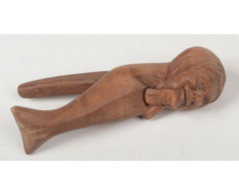 An early 20th century Continental carved wood nut cracker formed as an old woman, 21.25cm.  Good condition. Good action.