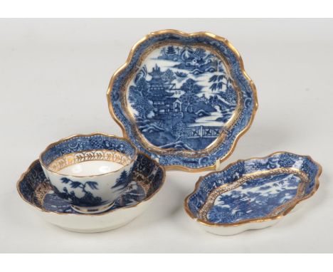 A Caughley spoon tray, teapot stand and a teabowl and saucer of scalloped form. Printed in underglaze blue with the Pagoda pa
