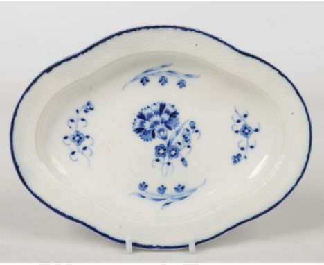 A Caughley stand of quatrefoil shaped. Ozier moulded and painted in underglaze blue with a central carnation and four sprigs.