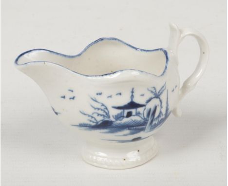 A rare Caughley butterboat with double scrolling handle. Having gadroon moulded rim and foot, painted in underglaze blue with