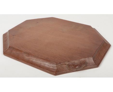 A Robert Thompson Mouseman cheeseboard of canted rectangular form. With adzed top and carved mouse motif, 31cm wide.  Good co