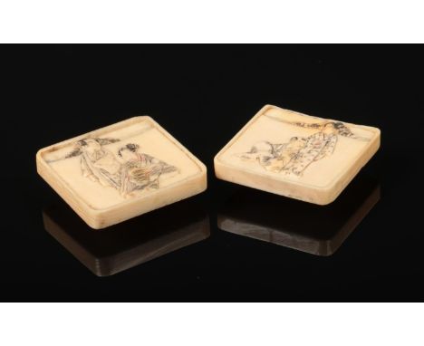 A pair of Japanese Meiji period carved ivory square formed buttons. Decorated in light relief with figures and having stained