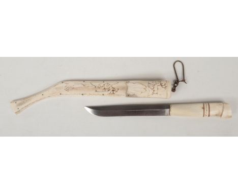 An inuit antler dagger and scabbard. With penwork decoration depicting reindeer, 36cm.  