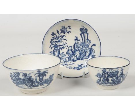 A Caughley teabowl and saucer printed in underglaze blue with the Mother and child and Bell Toy patterns along with a small C