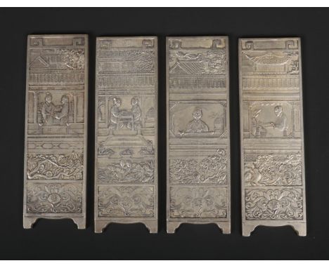 A Chinese white metal miniature four panel screen. Decorated in relief each representing a different pastime, chess, study, m