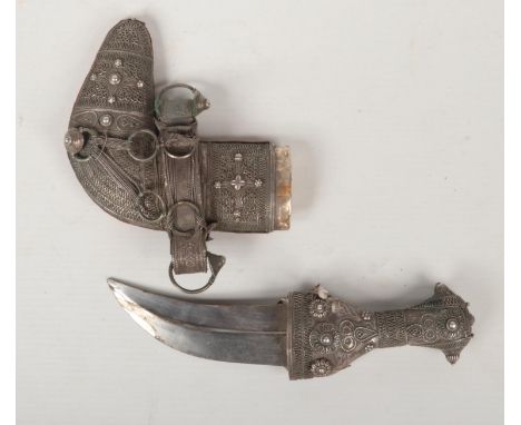 A silver mounted Janbiya dagger in scabbard, 19cm.  Blade loose from the grip.