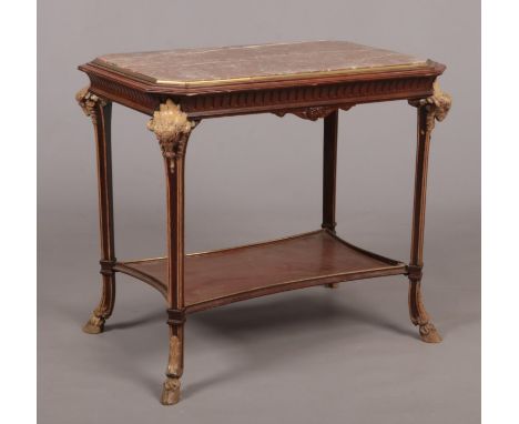 A French Empire style marble top centre table. With painted carved ram mask terminals and hoof feet. 80cm x 55cm, 72cm high. 