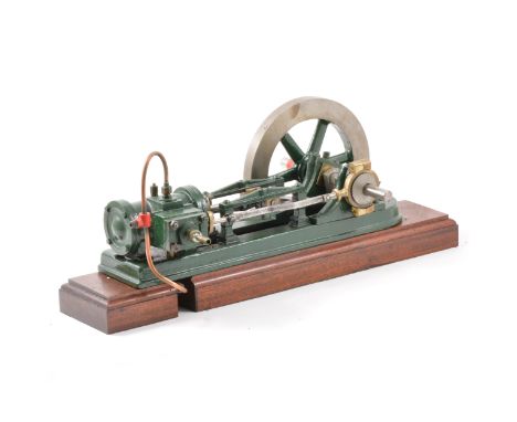 A well-built horizontal live-steam engine, single cylinder, with 6.5inch flywheel, mounted onto wooden base, 37cm in length, 