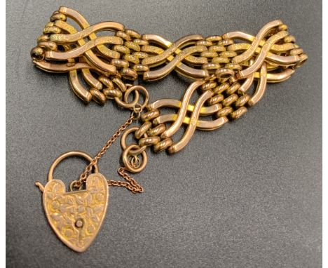 A 9ct gold decorative gate bracelet with etched padlock fastener. 23.4gms.Condition ReportGood condition.