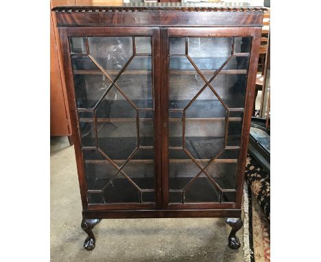 A mahogany 2 door display cabinet with astragal glazed doors , cabriole legs and claw ball feet. 84cms w x 29cms d x 125cms h