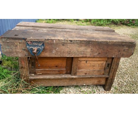 A vintage wooden workbench with cupboards to base at both sides. 153 x 78 x 78cms h with two Parkinson's Perfect vise No.14 a