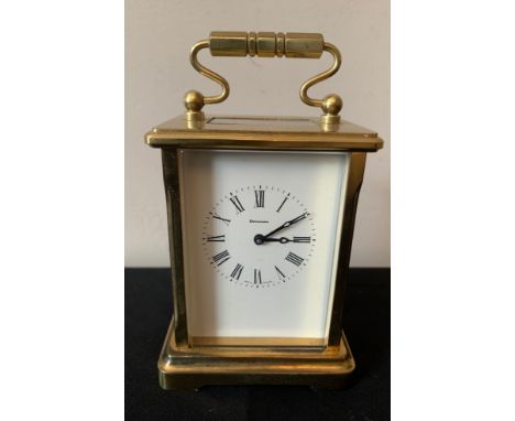A Dominion carriage clock, 8 day, English made. Height to handle 16cms.Condition ReportGood working order.