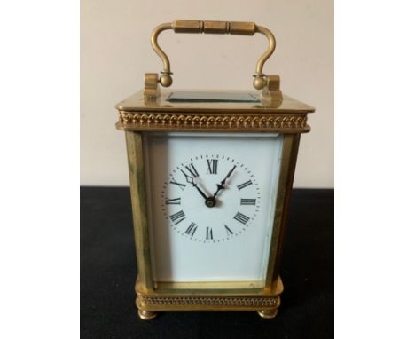 An 8 day carriage clock, cornice case with white enamel face. Height to handle 16cms.Condition ReportGood working order.