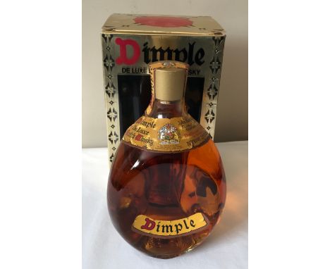 A boxed John Haig's Dimple deluxe scotch whisky 26 2/3 fluid ounces.Condition ReportSealed. Box with some creasing.