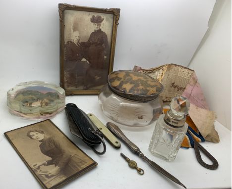 A miscellany to include pen knives, button hook, Torquay paperweight, silver necked glass scent bottle etc.Condition ReportIt