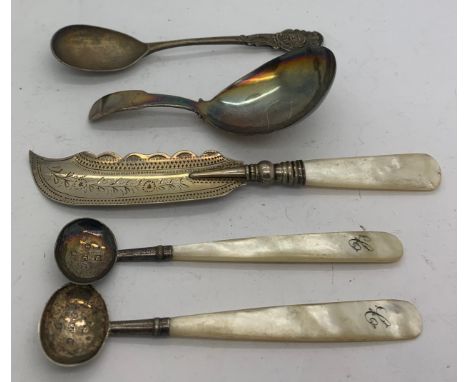 A Georgian silver caddy spoon London 1815, 2 Georgian silver and mother of pearl salt spoons, butter knife and another spoon.