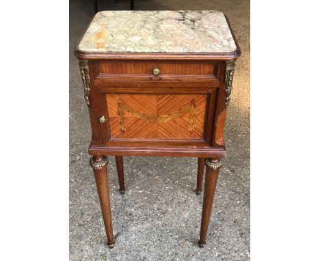 A French walnut bedside cabinet with coloured marble top, white marble interior, decorative brass fittings and quarter veneer