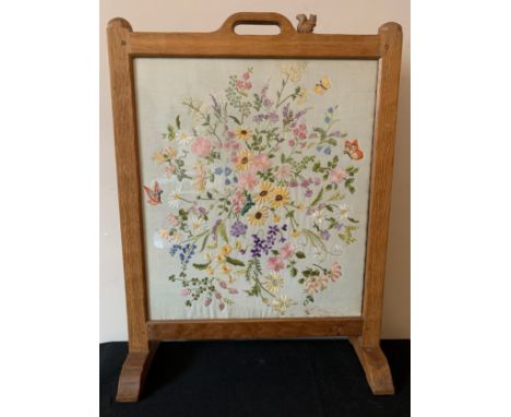An oak Wilf "Squirrelman" Hutchinson firescreen with embroidered needlework panel. 73 x 55cms.Condition ReportGood condition.